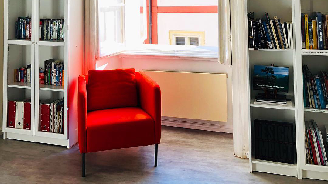 Red armchair in the open library.