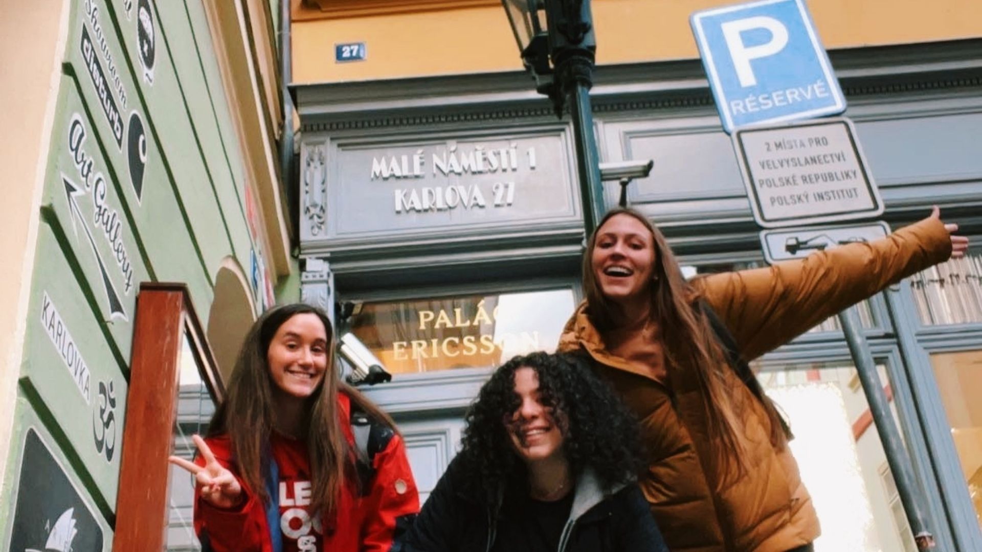 Reagan Glass at the entrance to NC State European Centre in Prague with two of her friends