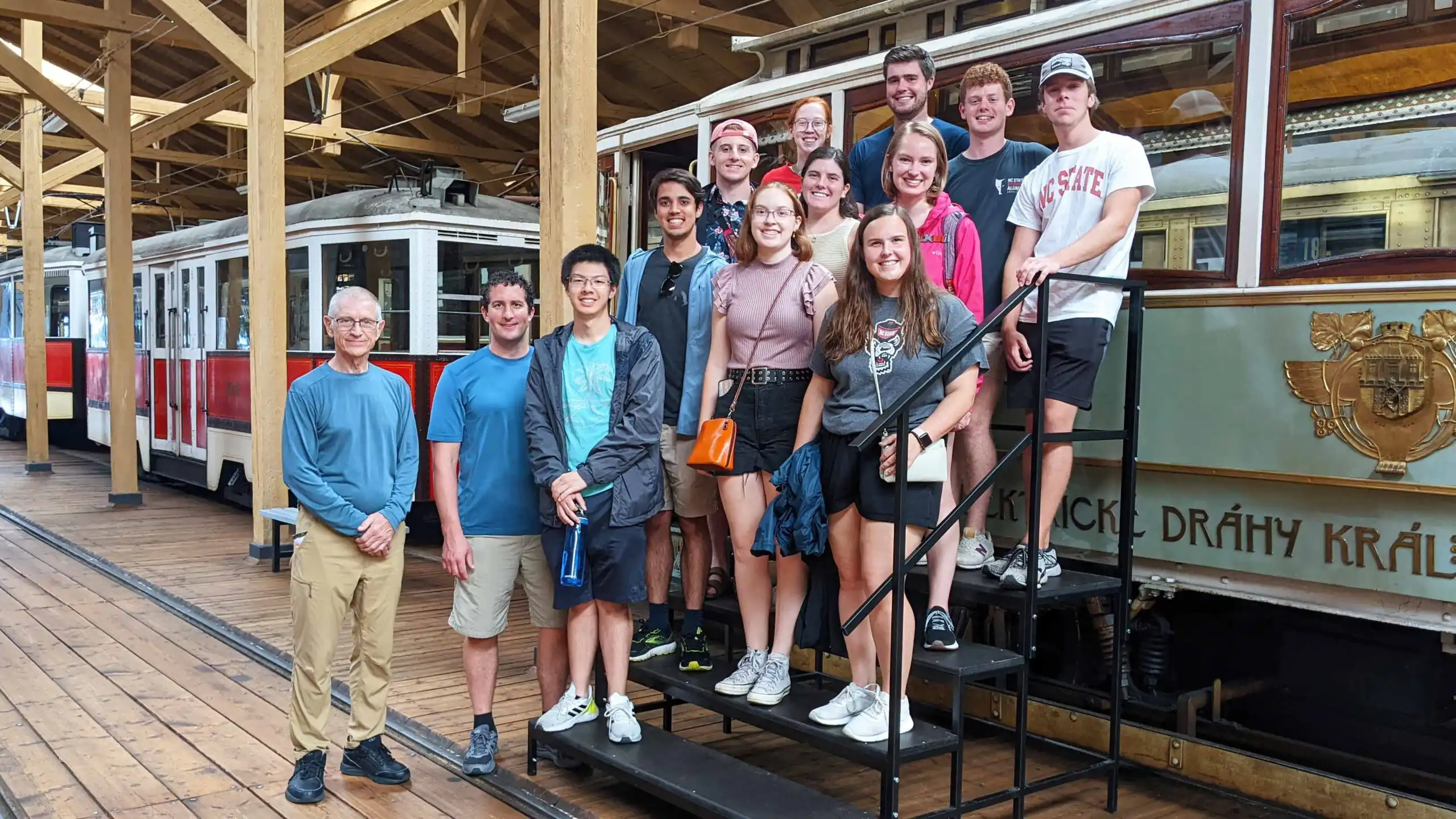 NC State civil engineering students at the Prague Transit  Museum posing with an old historic tram.