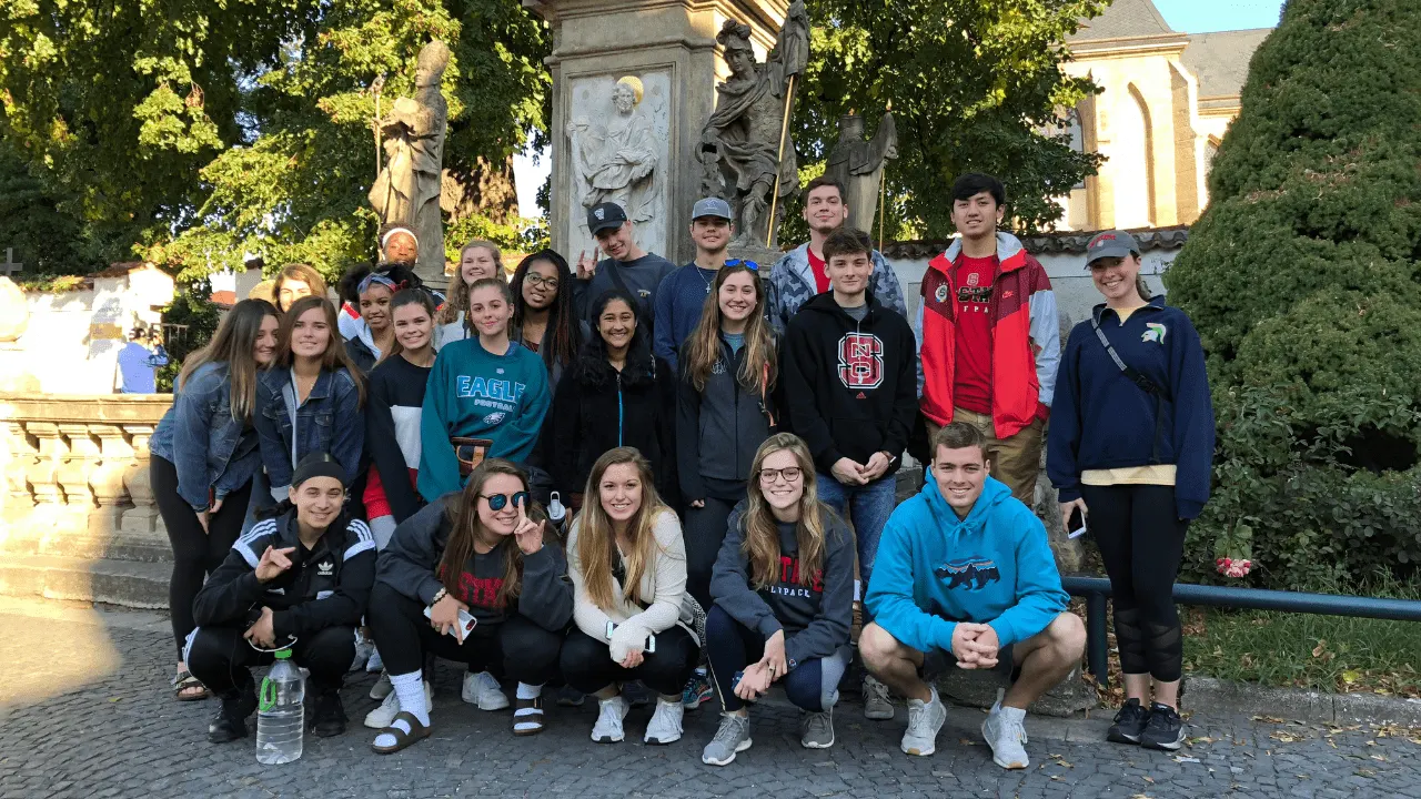 Students taking a group picture in front church during excursion.