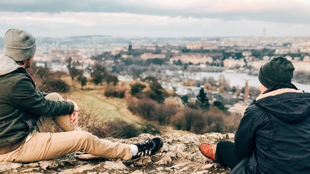 Two students overlooking the Vltava river from a rocky view point
