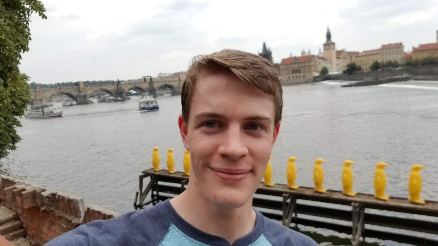 A student, Justin, next to Charles Bridge by the river