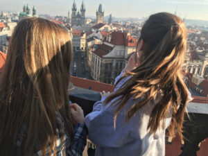 A student, Madeline, looking over the city of Prague with her friend.