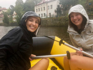 A student, Kaitlyn, rafting with her friend while it is raining.