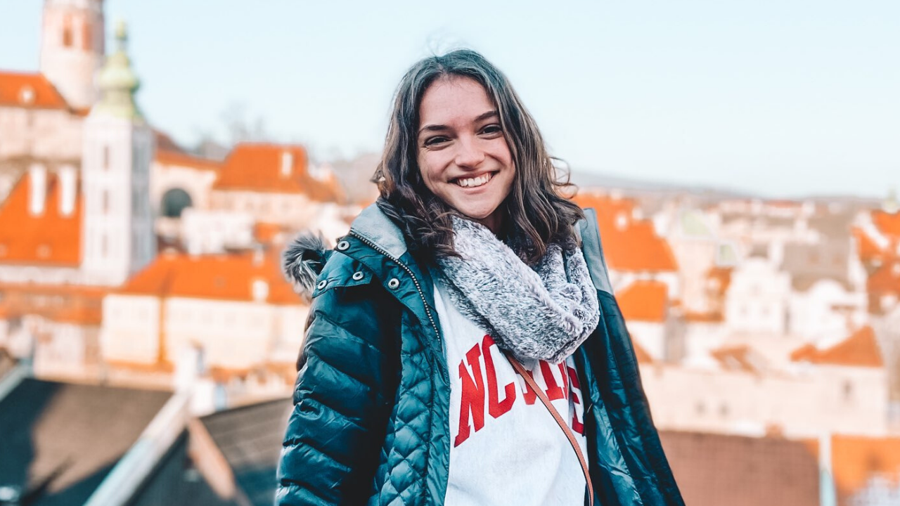 Smiling female student with Cesky Krumlov in the background