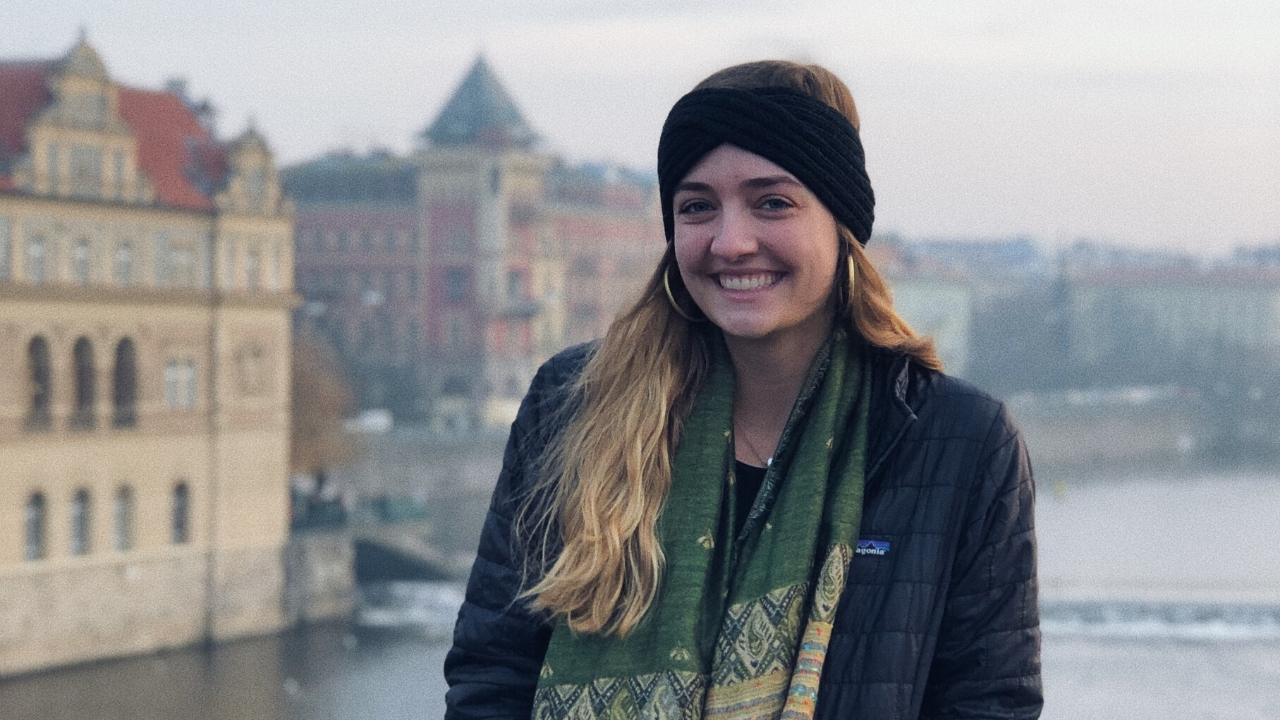 Smiling girl student in Prague