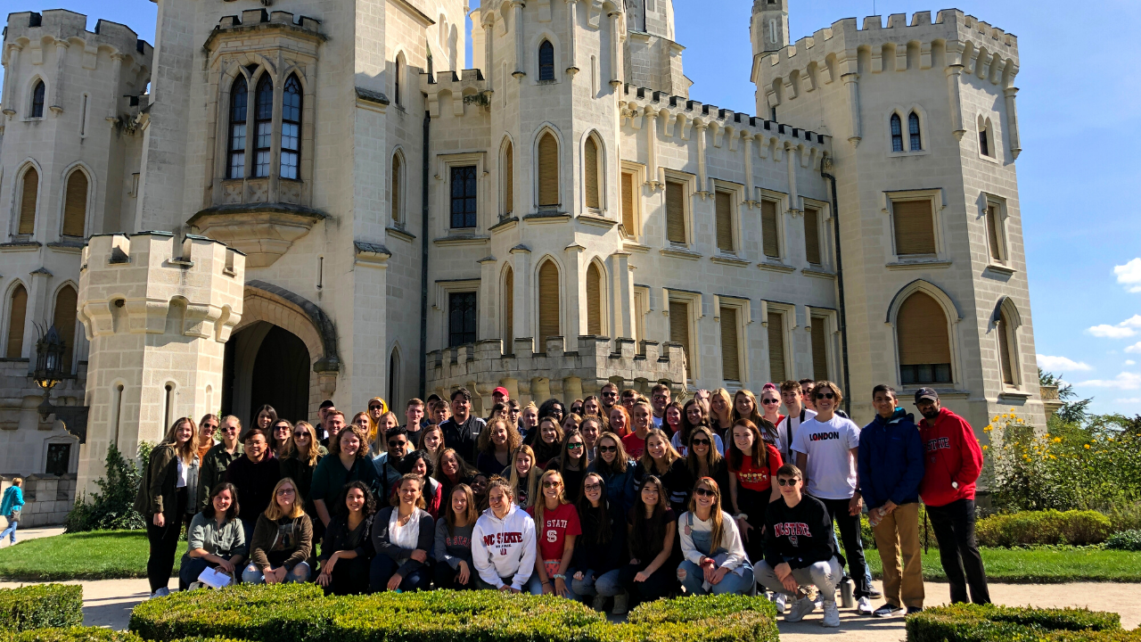 Group of about 60 students in front of Czech castle Hluboka
