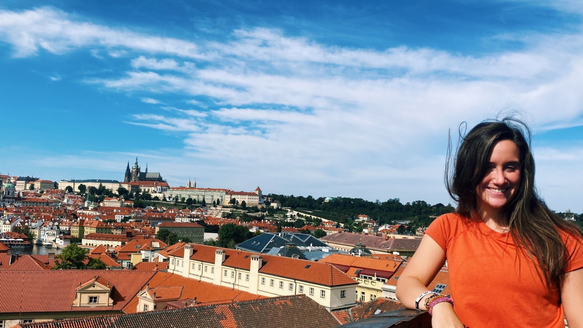 Reagan Glass taking a photo with Prague Castle in the background