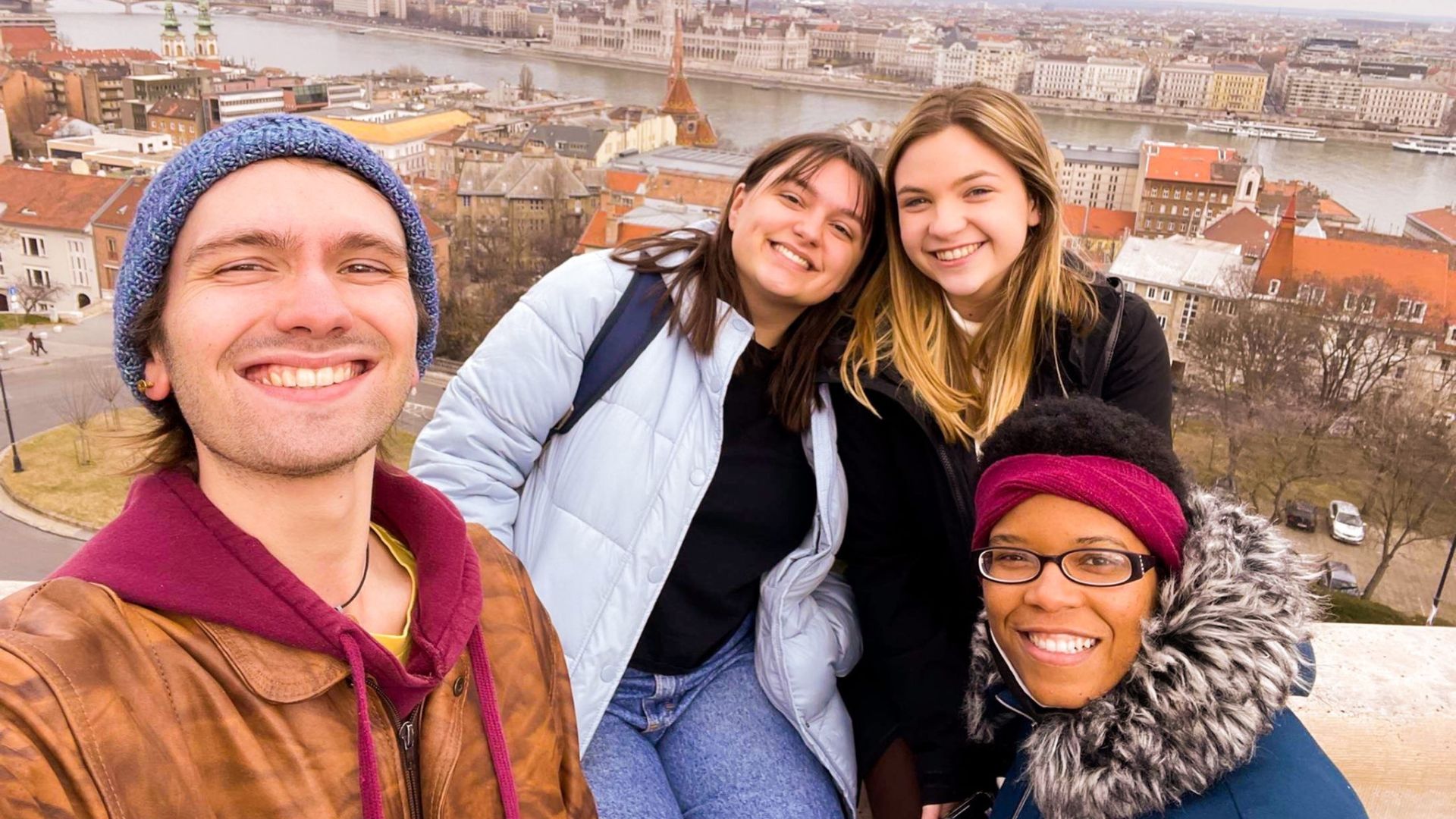 Katie Gray taking a photo with three of her friends in Prague