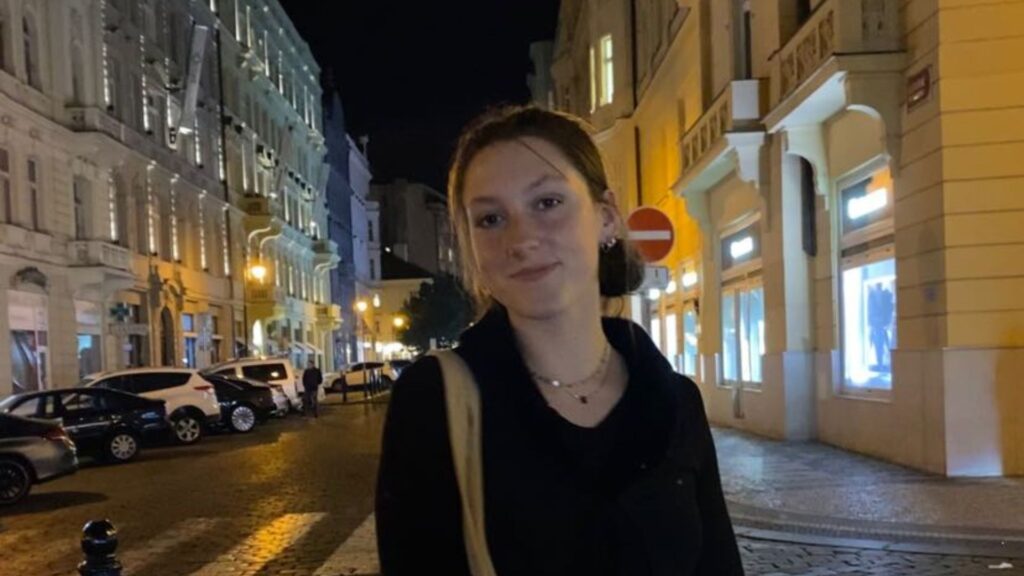 A student, Rowan, posing for a picture in the night streets of Prague.